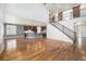 Bright and airy living room with hardwood floors, modern staircase, and open concept to the kitchen at 8259 Arapahoe Peak St, Littleton, CO 80125