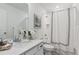 A clean bathroom with a sink with a marble countertop, a toilet and a shower with curtain at 645 Flintwood Pl, Lafayette, CO 80026