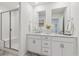 Bathroom featuring a glass enclosed shower and double sinks with marble countertops at 645 Flintwood Pl, Lafayette, CO 80026