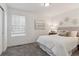 Bedroom with carpet, white walls, a window, a queen bed and a decorative painting at 645 Flintwood Pl, Lafayette, CO 80026