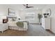Serene bedroom with soft lighting, a ceiling fan, neutral decor, and a large window for natural light at 645 Flintwood Pl, Lafayette, CO 80026