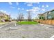Attractive outdoor common area with a gravel groundcover, trees and a grassy lawn surrounded by neighboring homes at 645 Flintwood Pl, Lafayette, CO 80026