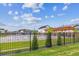 Modern community pool area with landscaping, a pergola, and decorative fencing at 645 Flintwood Pl, Lafayette, CO 80026