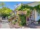 Quaint bakery exterior featuring a rustic wooden sign, lush greenery, and charming entrance steps at 645 Flintwood Pl, Lafayette, CO 80026
