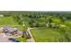 Aerial view of a lush golf course with winding paths, manicured greens, and rows of parked golf carts at 645 Flintwood Pl, Lafayette, CO 80026