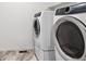 A laundry room with a front loading washer and a front loading dryer at 645 Flintwood Pl, Lafayette, CO 80026