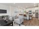 Open living space with a kitchen island, stainless appliances, and a comfortable seating area with a TV at 645 Flintwood Pl, Lafayette, CO 80026