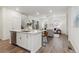 Open-concept living area with hardwood floors, large windows, and a seamless flow to the kitchen at 645 Flintwood Pl, Lafayette, CO 80026