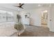 A main bedroom with carpet, a ceiling fan, and a decorative mirror with a tree at 645 Flintwood Pl, Lafayette, CO 80026