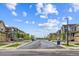 View of a quiet, tree-lined residential street with sidewalks and modern homes at 645 Flintwood Pl, Lafayette, CO 80026