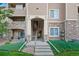 Well-maintained condo building with inviting entrance and lush green landscaping at 9518 W San Juan Cir # 307, Littleton, CO 80128