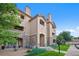 Beautiful condominium complex featuring stone accents, balconies, and manicured landscaping at 9518 W San Juan Cir # 307, Littleton, CO 80128