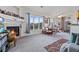 Bright living room featuring a cozy fireplace and large windows with mountain views at 9518 W San Juan Cir # 307, Littleton, CO 80128