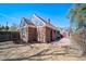 Charming brick home with a spacious backyard featuring a stone patio and privacy fence at 7275 E 8Th Ave, Denver, CO 80220
