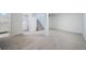 Finished basement with carpet, laundry area, and staircase at 7275 E 8Th Ave, Denver, CO 80220