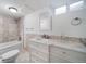 Updated bathroom features shower-tub combination, modern vanity, and stylish tile at 7275 E 8Th Ave, Denver, CO 80220