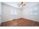 A bright bedroom with two large windows, hardwood floors and a ceiling fan at 7275 E 8Th Ave, Denver, CO 80220