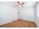 The bedroom features hardwood floors, a ceiling fan, and natural light from the window at 7275 E 8Th Ave, Denver, CO 80220