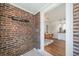 Charming entryway with exposed brick, leading into the dining and kitchen areas at 7275 E 8Th Ave, Denver, CO 80220