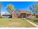 Inviting home showcasing a covered front porch, brick facade, and well-manicured lawn at 7275 E 8Th Ave, Denver, CO 80220