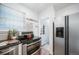 Efficient kitchen featuring stainless steel appliances and easy access to the backyard at 7275 E 8Th Ave, Denver, CO 80220