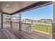 Wide covered porch with nice trim and stone columns offers relaxing neighborhood views at 8386 Cokedale Cir, Littleton, CO 80125