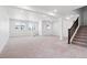 Large, carpeted basement features multiple windows, recessed lighting, and stairs to upper level at 8386 Cokedale Cir, Littleton, CO 80125