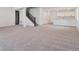 Large, carpeted basement features multiple windows, recessed lighting, wet bar and stairs to upper level at 8386 Cokedale Cir, Littleton, CO 80125