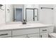 Bathroom with sleek black hardware, large mirror, and shower with a glass door at 8386 Cokedale Cir, Littleton, CO 80125