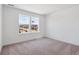 Bedroom featuring two windows, neutral carpet, baseboards, and white walls at 8386 Cokedale Cir, Littleton, CO 80125