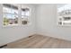 A clean, empty room with wood floors and bright natural light coming through large windows at 8386 Cokedale Cir, Littleton, CO 80125