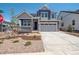 Two-story home with a two-car garage and landscaped front yard and stone masonry at 8386 Cokedale Cir, Littleton, CO 80125
