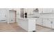 Bright kitchen with white cabinetry, stainless steel appliances, and large kitchen island at 8386 Cokedale Cir, Littleton, CO 80125