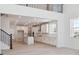 Open concept kitchen with white cabinets, modern appliances, and an airy design at 8386 Cokedale Cir, Littleton, CO 80125