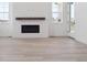 Open living room area featuring a modern fireplace and neutral design elements at 8386 Cokedale Cir, Littleton, CO 80125