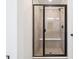 Elegant shower enclosure featuring a black frame and neutral tiling at 8386 Cokedale Cir, Littleton, CO 80125