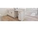 Wet bar with a sink, white cabinets and drawers, and a stone countertop at 8386 Cokedale Cir, Littleton, CO 80125
