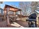 Outdoor deck with a grill and a covered dining area, perfect for barbecues and entertaining friends outdoors at 4217 S Jericho St, Aurora, CO 80013