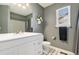 Clean bathroom featuring a white vanity, a toilet, and tiled floors and shower creating a tranquil space at 4217 S Jericho St, Aurora, CO 80013