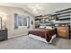 Stylish bedroom with a decorative wood accent wall, a comfortable bed, and lots of natural light at 4217 S Jericho St, Aurora, CO 80013