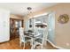 Cozy dining area with a bay window, stylish lighting, and charming decor accents creating a warm atmosphere at 4217 S Jericho St, Aurora, CO 80013