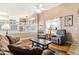 Cozy living room featuring hardwood floors, comfortable seating, and a bright, open layout to the kitchen at 4217 S Jericho St, Aurora, CO 80013