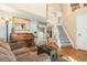 Inviting living room featuring hardwood floors, a cozy sofa, and a stairway leading to the second floor at 4217 S Jericho St, Aurora, CO 80013