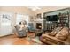 Comfortable living room with a brick fireplace, hardwood floors, and plush seating for relaxing at 4217 S Jericho St, Aurora, CO 80013