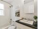 Bright bathroom with white subway tile, a shower-tub combination, and a modern sink and vanity at 4353 Sherman St, Denver, CO 80216