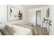 Bright bedroom with a modern aesthetic featuring fresh white walls and carpet and minimalist decor at 4353 Sherman St, Denver, CO 80216