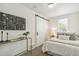 Cozy bedroom featuring natural light, fresh white walls, a sliding barn door, and stylish decor at 4353 Sherman St, Denver, CO 80216
