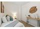 Inviting bedroom with a light blue and green color scheme, wood accents, and warm lighting at 4353 Sherman St, Denver, CO 80216