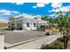 Modern commercial building with bright white exterior, expansive windows and outdoor seating at 4353 Sherman St, Denver, CO 80216