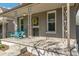 Close-up of a cozy front porch featuring stylish support beams and cheerful blue seating at 4353 Sherman St, Denver, CO 80216